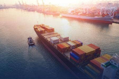 Container vessel carrying goods through an international port